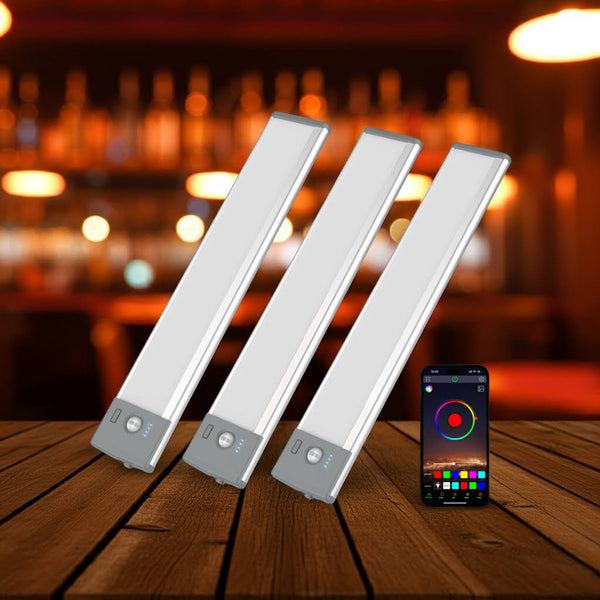 Three LED strip lights on a wooden surface with a smartphone displaying app interface in the background.
