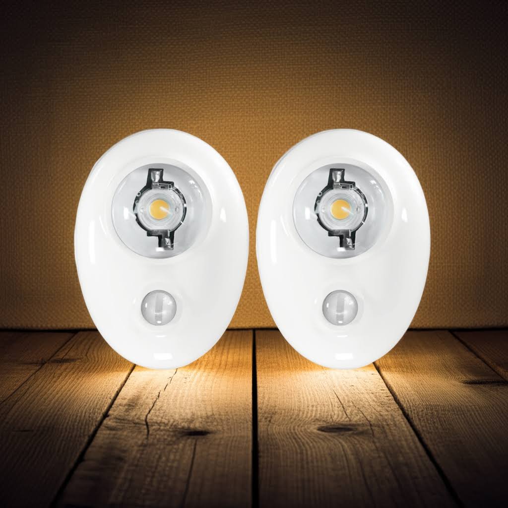 Two motion sensor lights on a wooden surface with a dark background